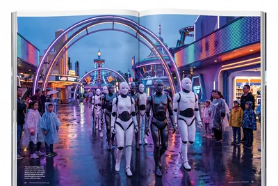 Editorial illustration of a group of humanoid robots in the plaza of a theme park at dusk