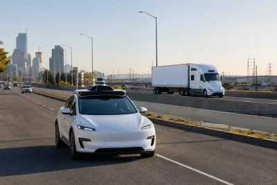 Lidar-equipped robotaxi driving on an urban road near an autonomous truck